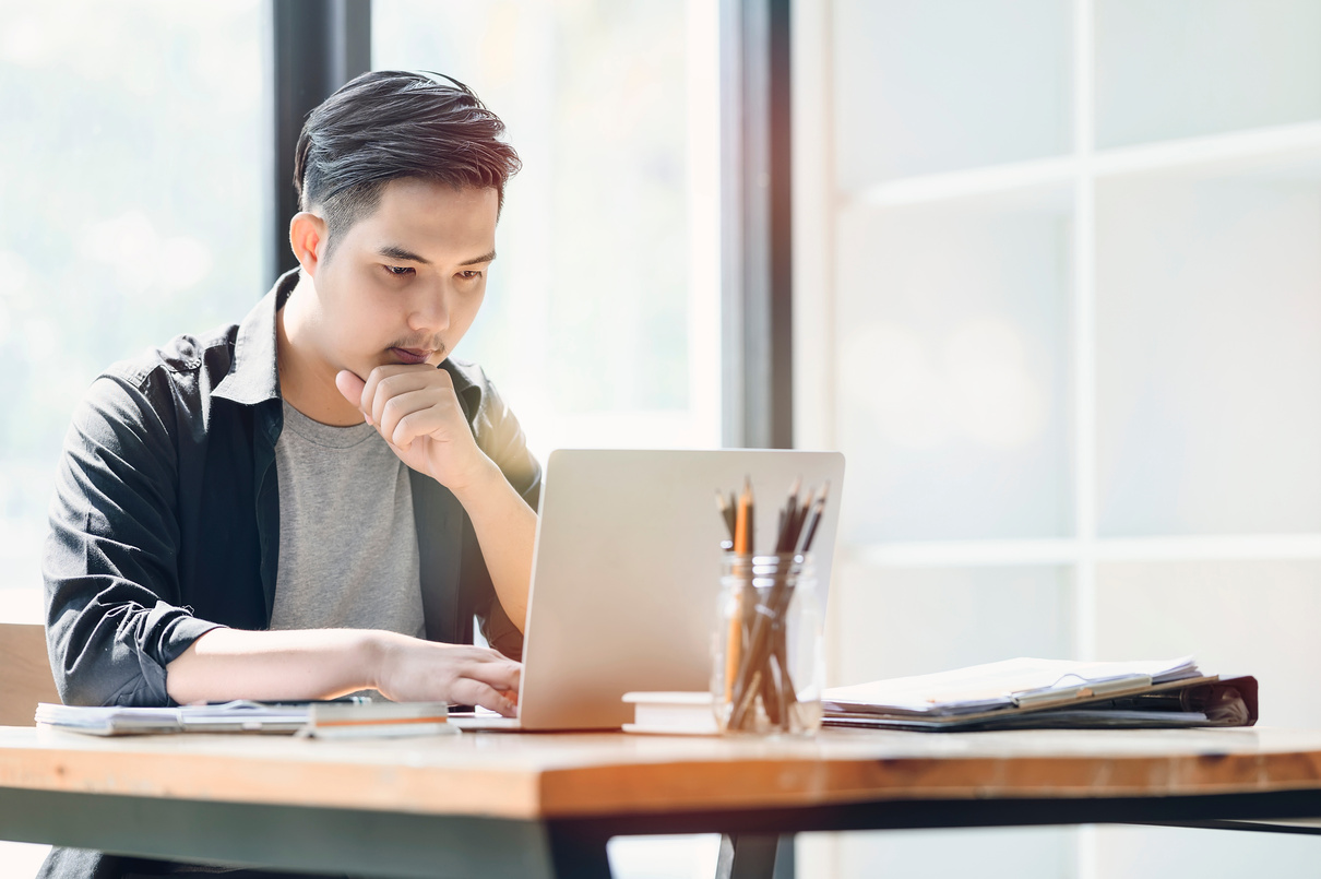 Young Man Working with Laptop 